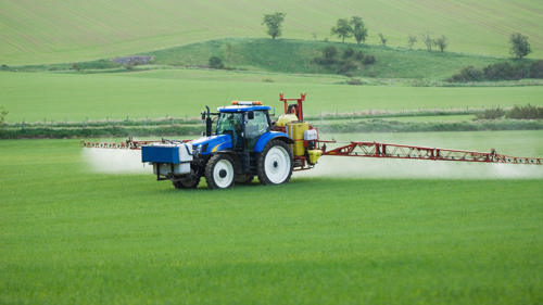 tractor watering grassfield